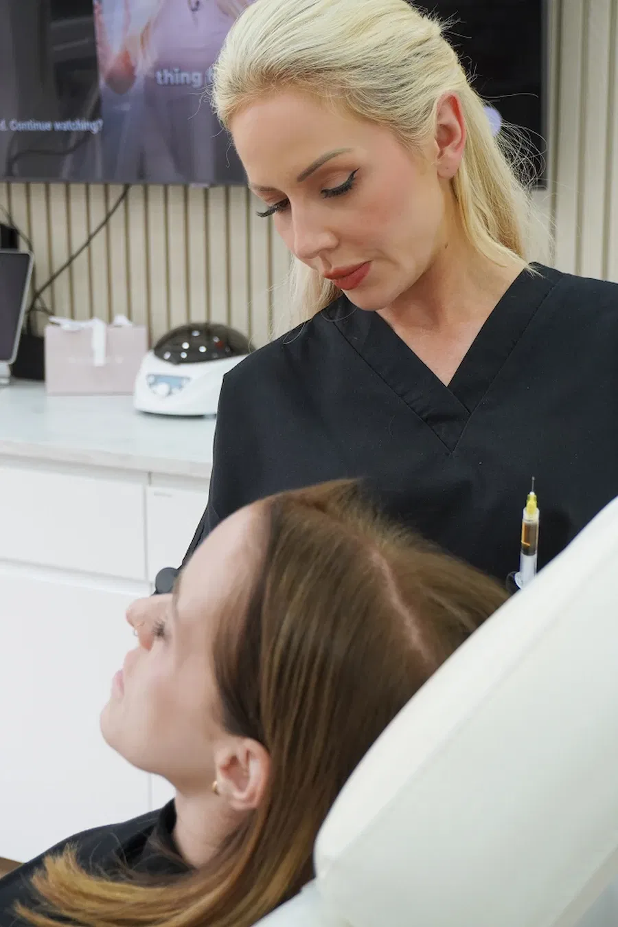 SLA Medical aesthetic practitioner examining a patient before administering cosmetic injectable treatment
